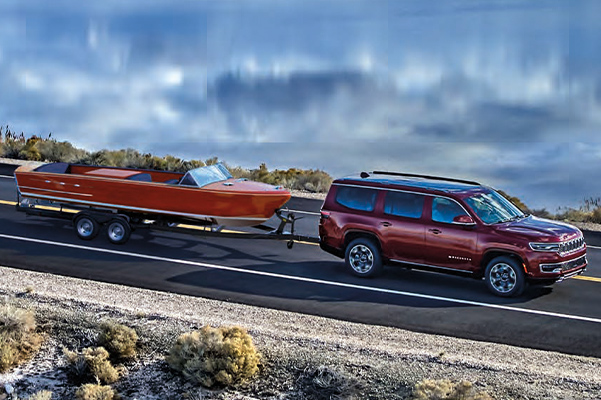 Wagoneer Series III in Velvet Red Pearl towing boat