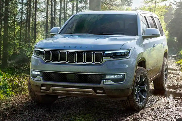 The 2022 Wagoneer being driven off-road on a muddy track.