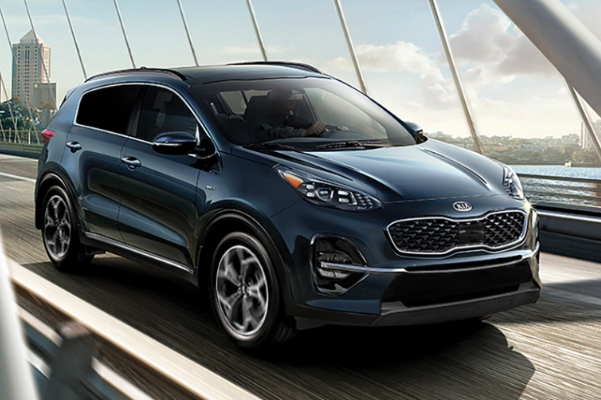 2022 Kia Sportage Driving Over A Bridge Three-Quarter View