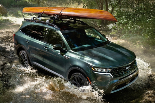 2022 Kia Sorento Driving Through A Stream With A Kayak Rack Equipped Three-Quarter View