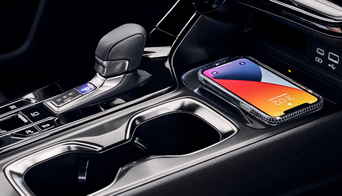 Detail shot of the wireless phone charger and gearshift of the 2022 Lexus NX