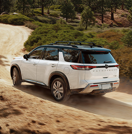 2022 Nissan Pathfinder rear view driving on dirt road