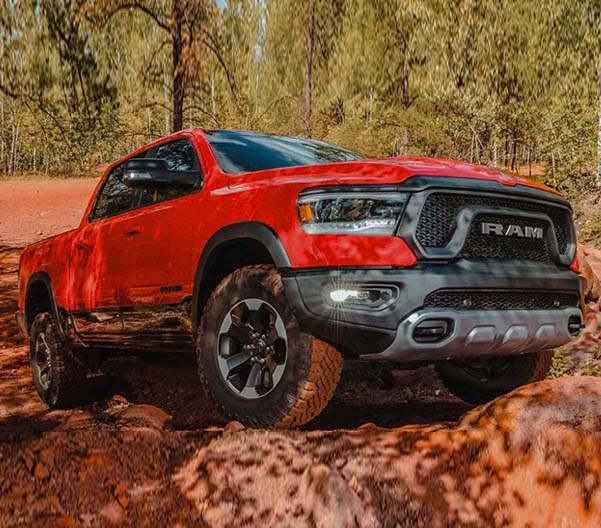 Closeup of a 2022 Ram 1500 driving over rocks
