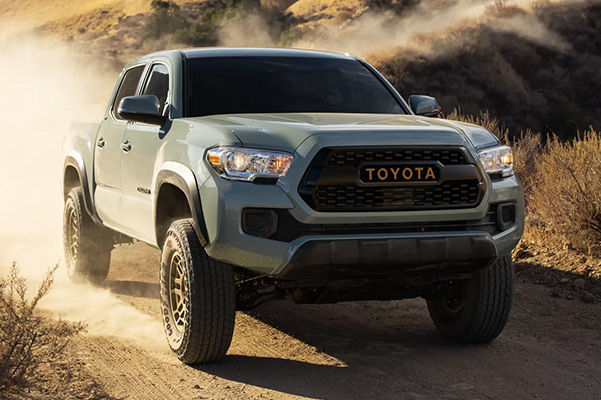 2021 toyota tacoma driving down a dirt road