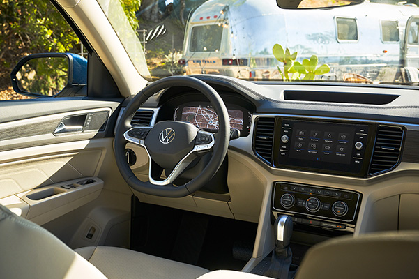A view from behind the driver’s seat of the interior dashboard and steering wheel of an Atlas.