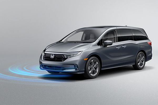 Front driver-side view of the 2023 Honda Odyssey Elite in Modern Steel Metallic, demonstrating Road Departure Mitigation System feature.