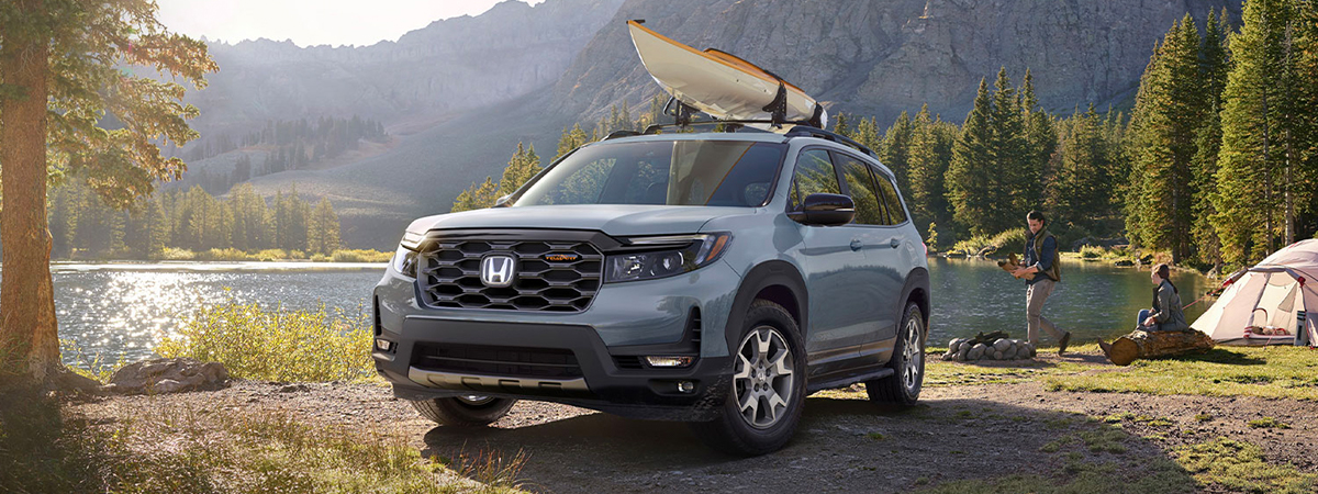 2023 Honda Passport parked in front of a lake