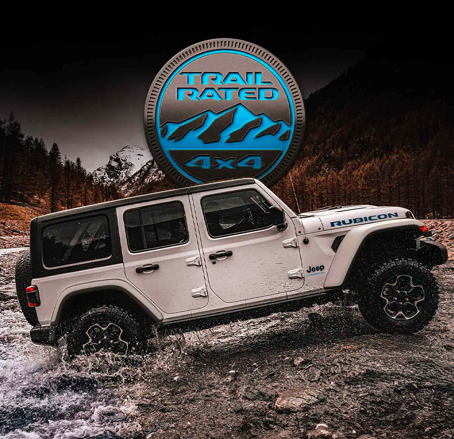 Trail Rated 4x4. The 2023 Jeep Wrangler Rubicon 4xe being driven out of a river and up the bank.