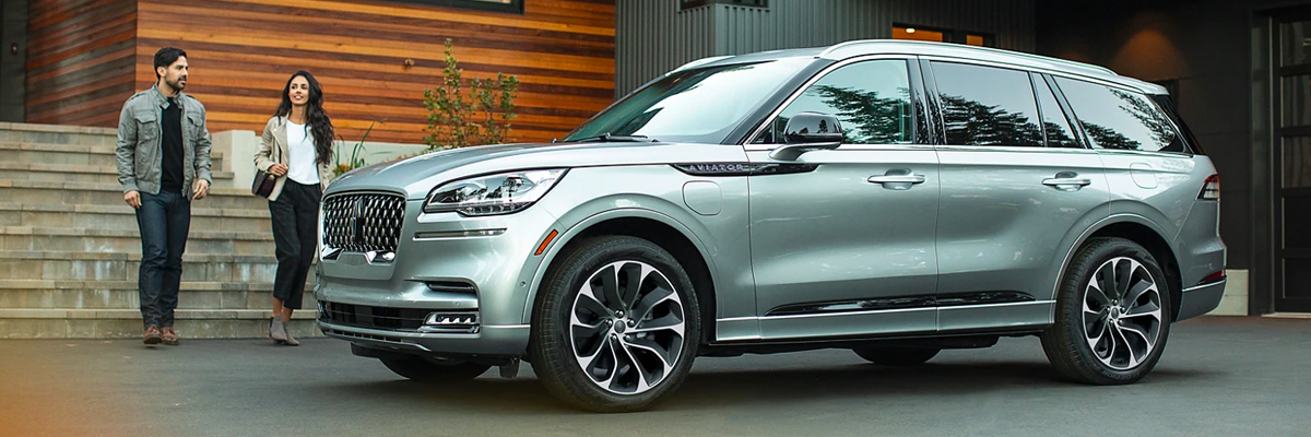 New Lincoln Navigator parked at luxury home.