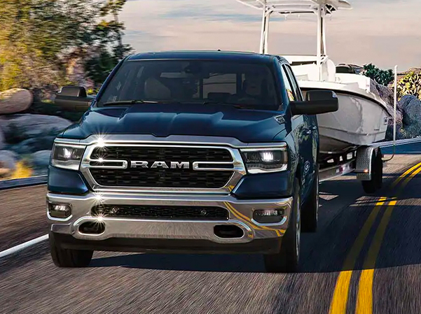 The 2023 Ram 1500 towing a motorboat.