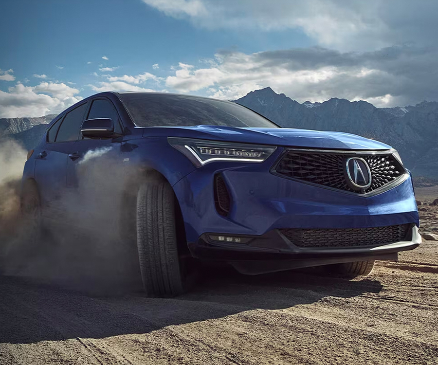 3/4 front view of the 2024 Acura RDX in motion on a dirt terrain
