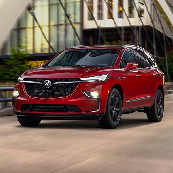 Red 2024 Buick Enclave driving through the city