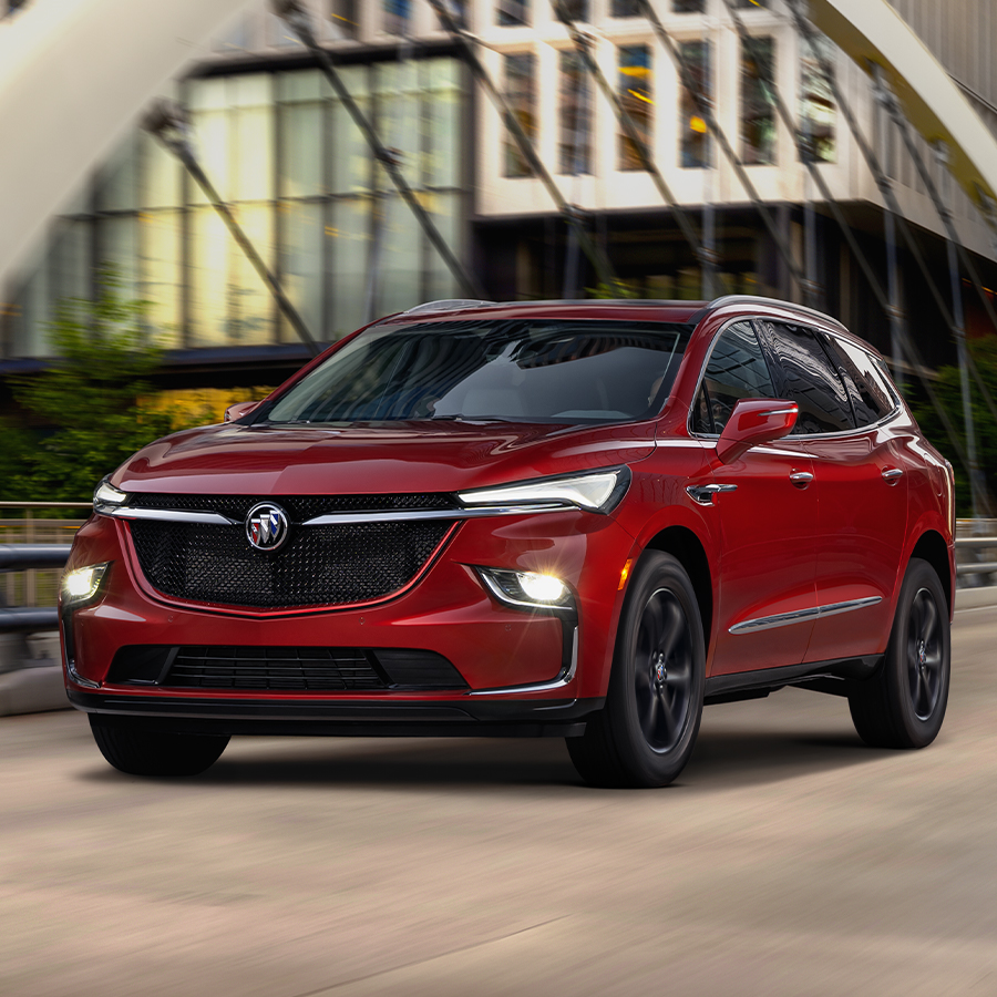 Red 2024 Buick Enclave driving through the city