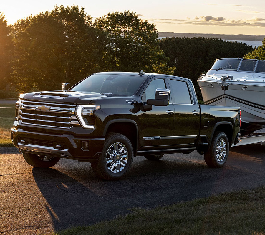 2024 Silverado HD Towing a Boat at Sunset