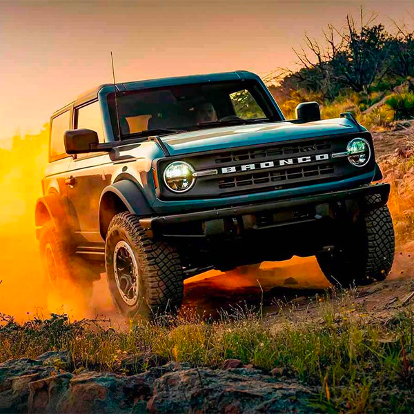 2024 Ford Bronco driving up a dirt trail