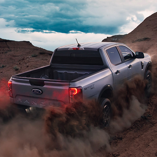 Rear view of the 2024 Ford Ranger driving up a mountain terrain
