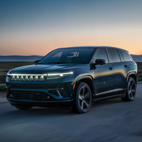 A 2024 Jeep Wagoneer S Launch Edition being driven on a desert road, at sunset.