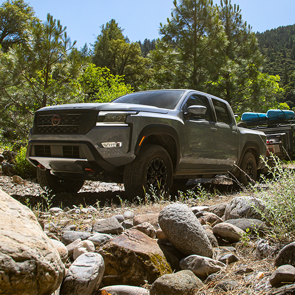 2024 Nissan Frontier driving over a rocky terrain