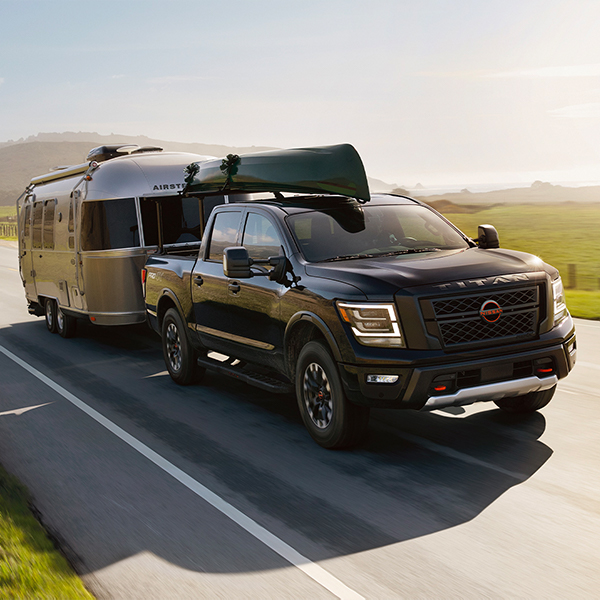 2024 Nissan TITAN towing a trailer on the road