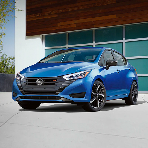 2025 Nissan Versa parked in front of a modern house
