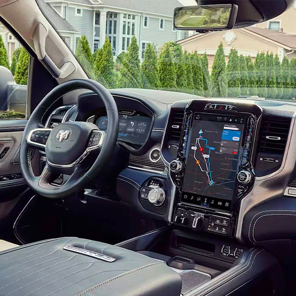 The interior of the 2024 Ram 1500 Limited Elite with the Uconnect touchscreen displaying a navigation map.