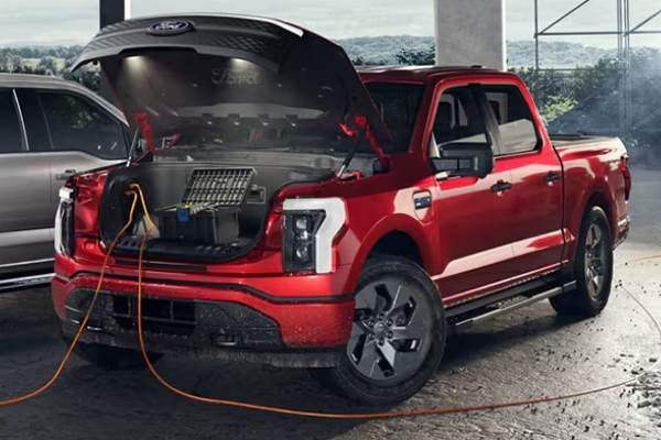 Side profile view of the 2025 Ford Maverick parked outside a multi color building