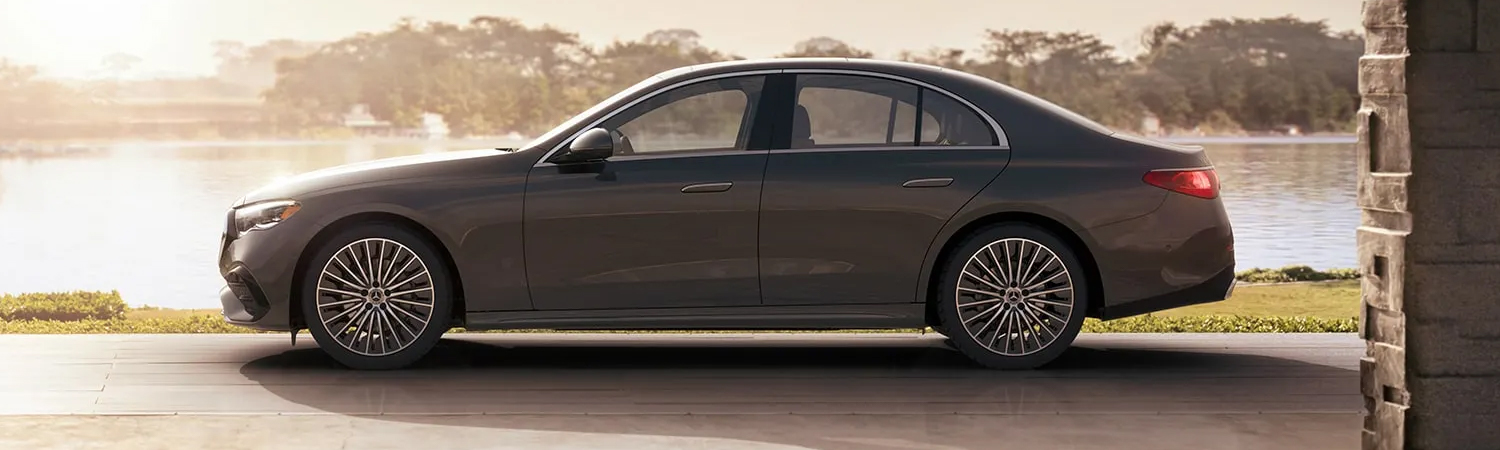Side view of the 2025 Mercedes-Benz E Class parked beside a lake
