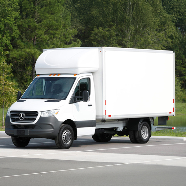 Sprinter Cab Chasis upfit parked in a parking lot with trees in the background