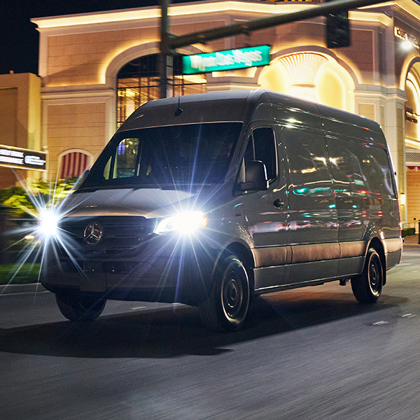 Front 3/4 shot of the 2025 Mercedes-Benz eSprinter Van driving down city street