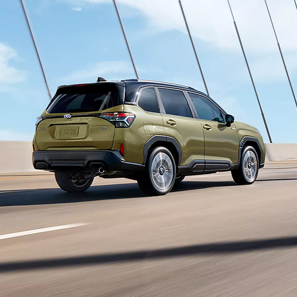2025 Subaru Hybrid SUV driving across bridge