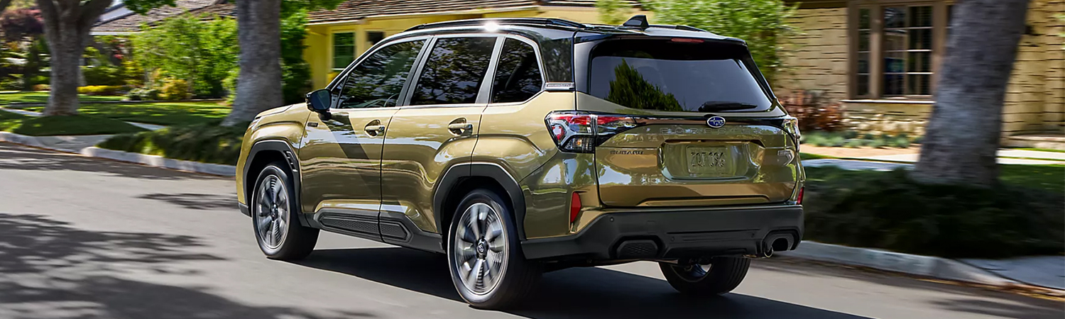 2025 Subaru Hybrid SUV driving on shadowy, neighborhood street