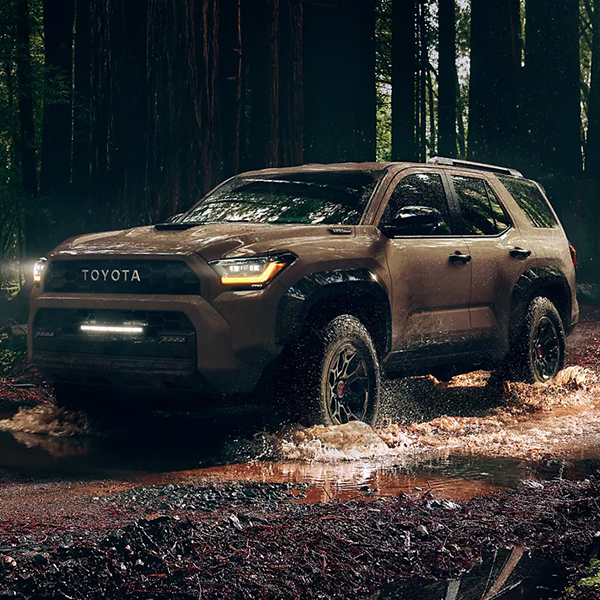 2025 Toyota 4Runner Hybrid driving through water in the woods