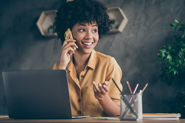 woman on computer and phone