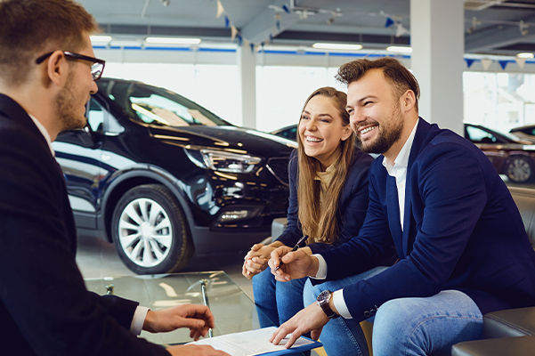 Couple buys a car in a car dealership