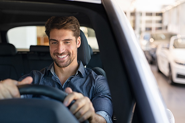 happy customer driving their new car