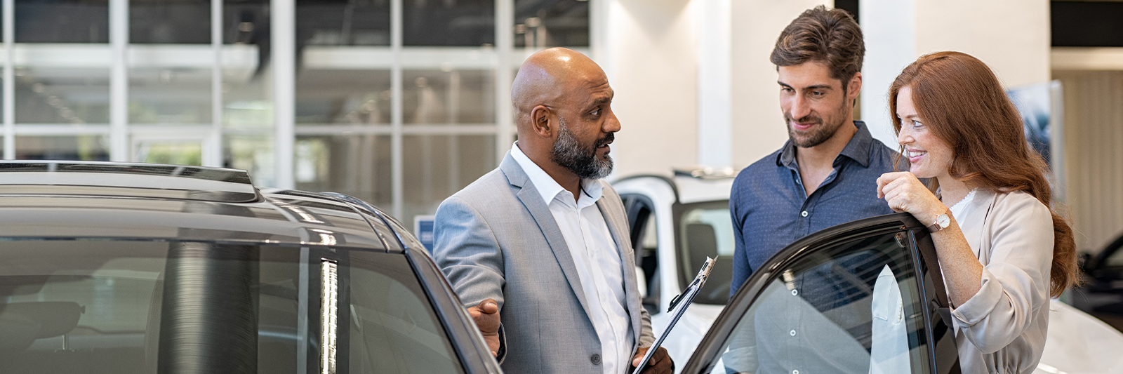 Showing cars to happy customers on the showroom floor