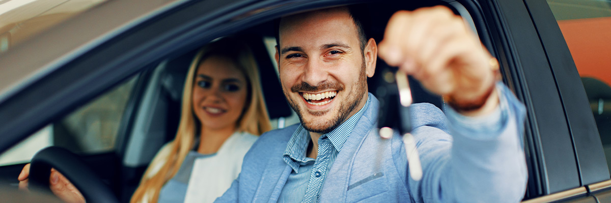 Customer holding car key while in a car