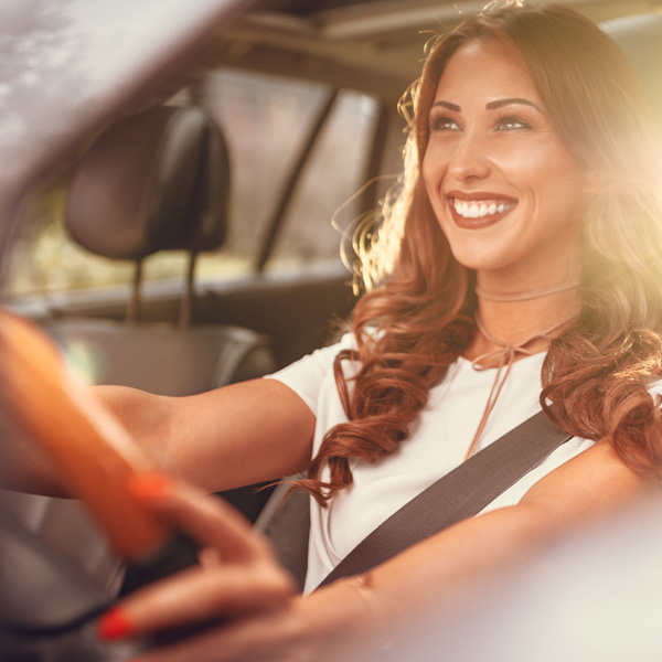 woman happy driving a car 