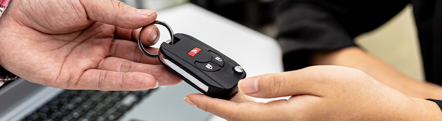 Two hands exchanging a set of keys