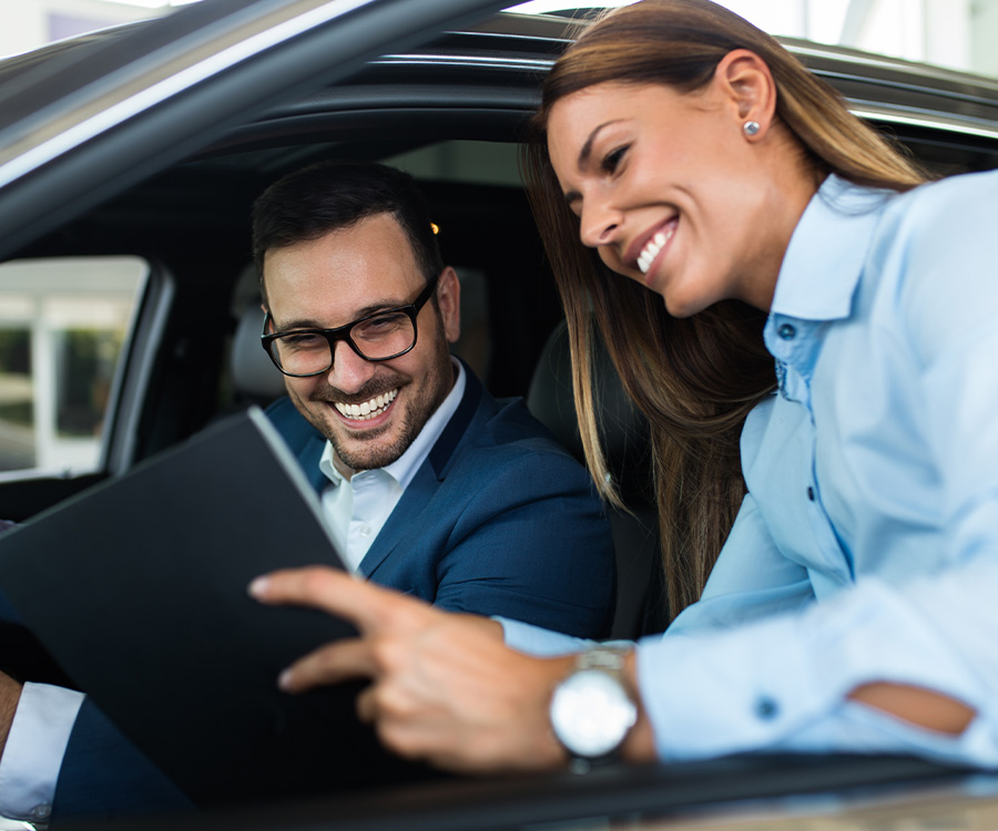 Dealership employee showing a customer their options on a tablet
