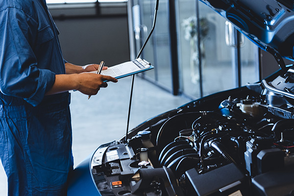 Mechanic inspecting car