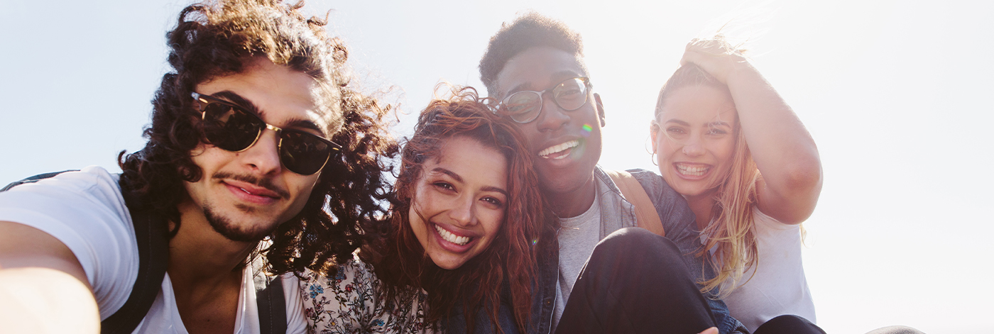 Group of happy friends taking a selfie on a nice day