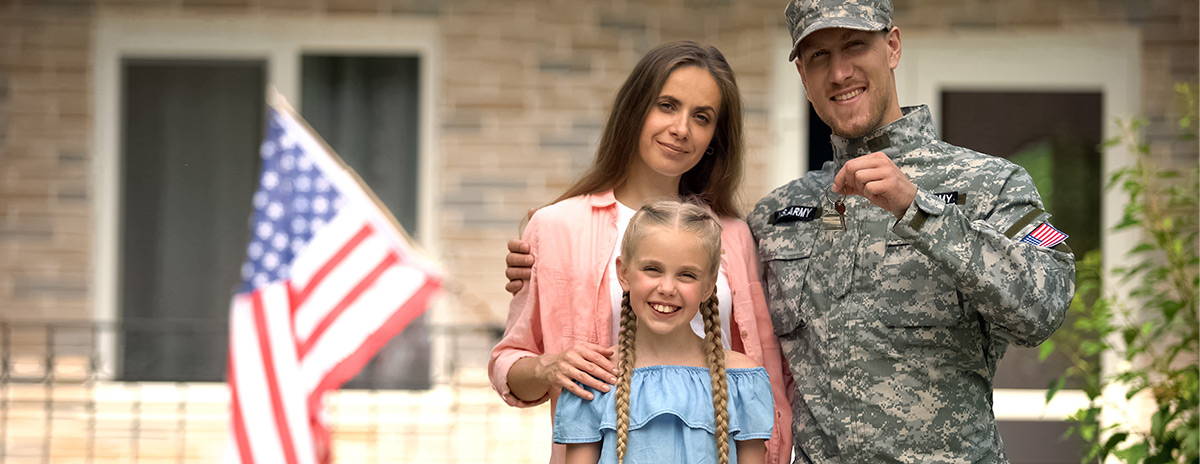 Soldier standing with family while holding car keys