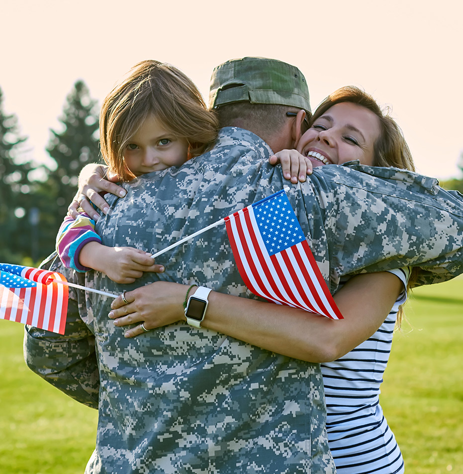 Happy family hugging with American flags in hand