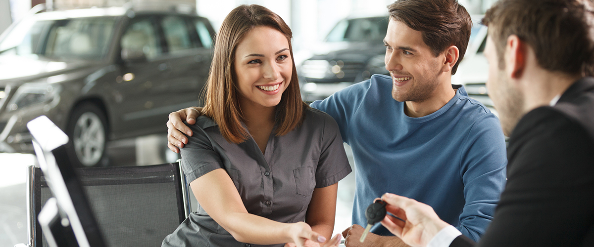 Happy customers buying a car!