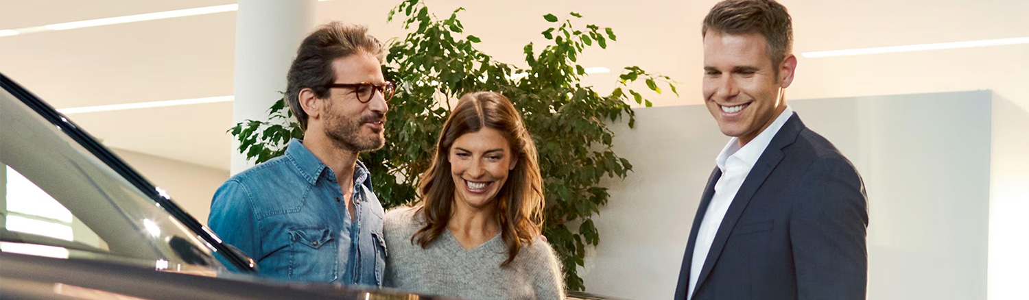 BMW customer service rep helping couple at BMW Center