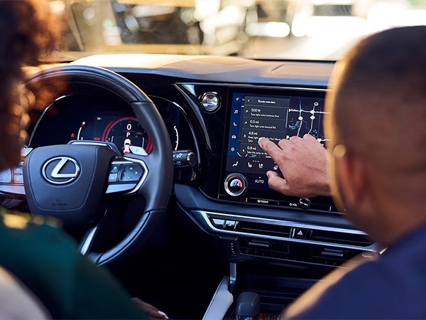 Two people sitting in their Lexus