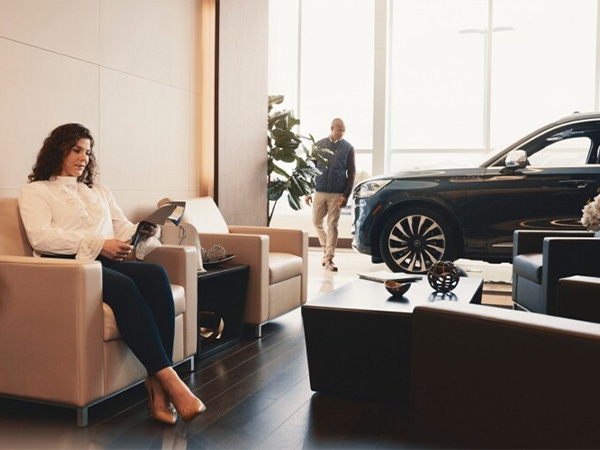 Woman sitting in the dealership waiting area