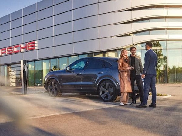 Two people speaking to dealership employee