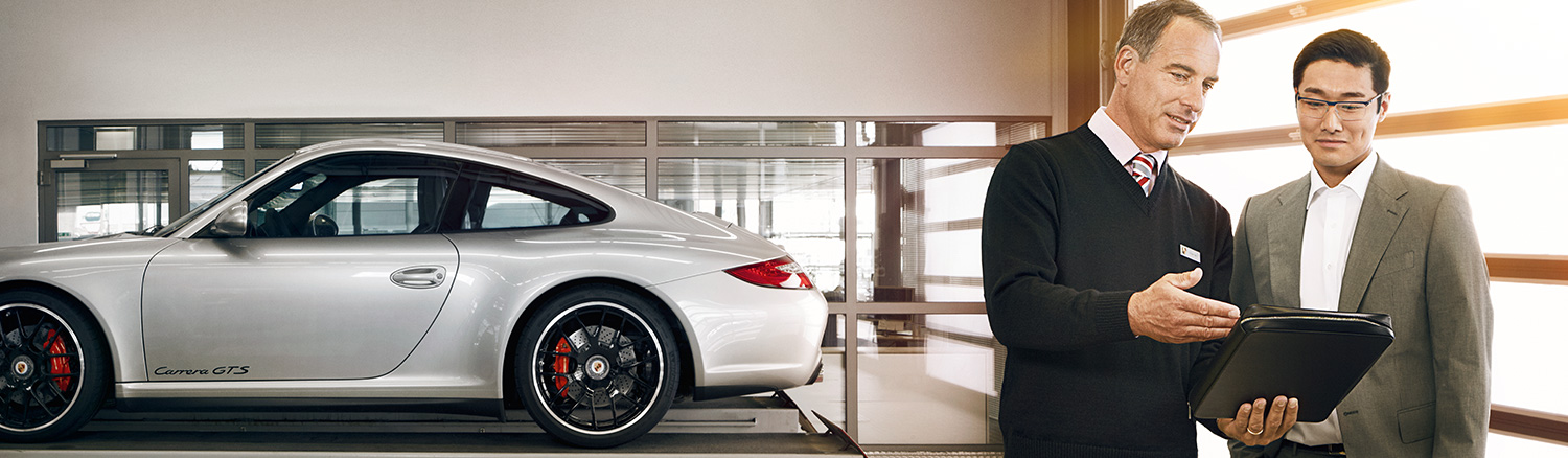Dealership employee and a customer in the sales room